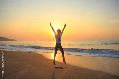 flying jump beach child girl on the beach in summer holiday, on sunset time.Happy little girl on the beach.soft focus