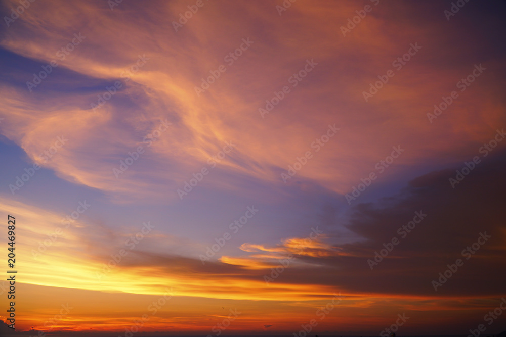 Beautiful dramatic sky. Sunset orange coulds . orange golden sunset. Sunset rays of the sun over the sea through the clouds skyward. Sunset natural composition