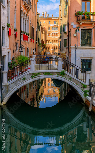 Weathered building facade on a picturesque canal in Venice Italy