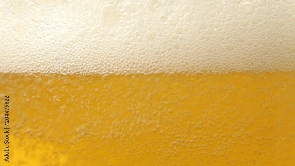 Close up of beer with bubbles. No sound. This file is cleaned and retouched. Close up of beer with bubbles. No sound. This file is cleaned and retouched.