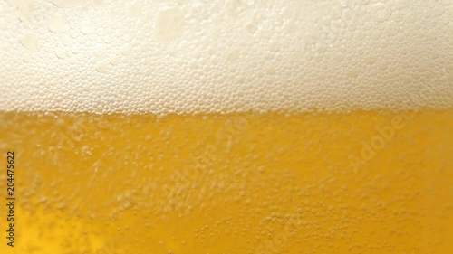 Close up of beer with bubbles. No sound. This file is cleaned and retouched.