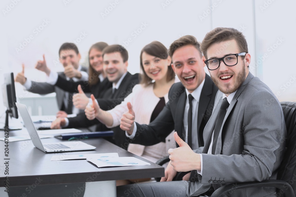 business team with thumbs up while sitting at his Desk business team with thumbs up while sitting at his Desk