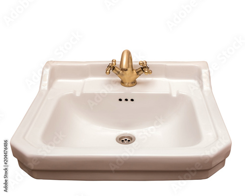 Ceramic beige sink with bronze tap, isolate.