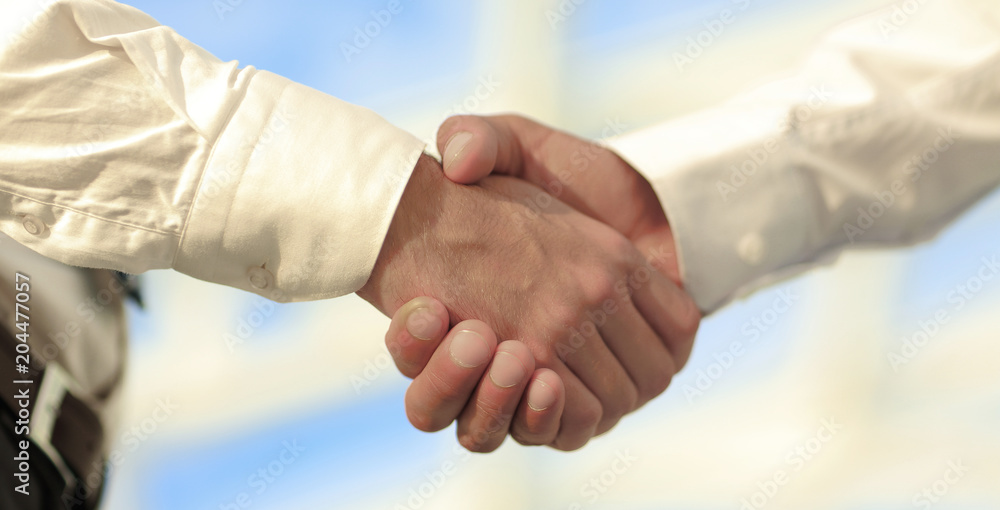 Close-up photo of handshake of two successful businessmen Close-up photo of handshake of two successful businessmen
