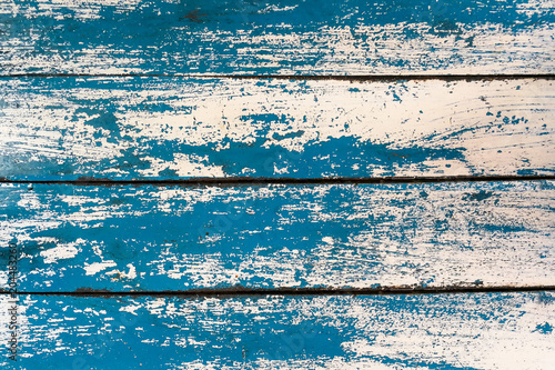 Grunge texture : Old wooden table painted with blue and white color, some color peeled off created unique texture.