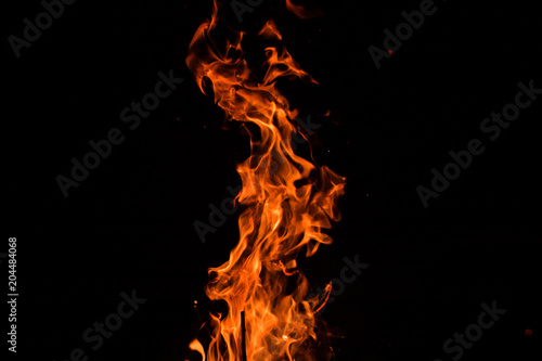 campfire flames on a black background © Mariusz