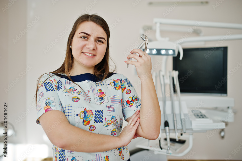 Portrait of baby dentist female at her dental office. Portrait of baby dentist female at her dental office.