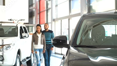 Mature African couple buying a car at the dealership