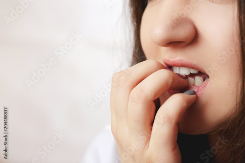 woman gnawing nails close-up  nervous  psychosis  white background