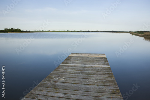 Wooden plank deck and lake