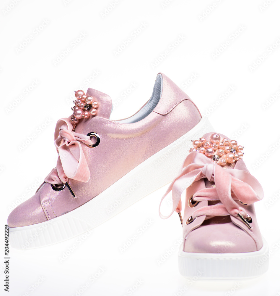 Hoop van Monteur staal Trendy sneakers concept. Footwear for girls and women decorated with pearl  beads. Pair of pale pink female sneakers with velvet ribbons. Cute shoes  isolated on white background. Stock Photo | Adobe Stock