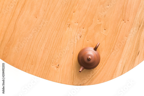 A teapot tea set on a cherry wooden table