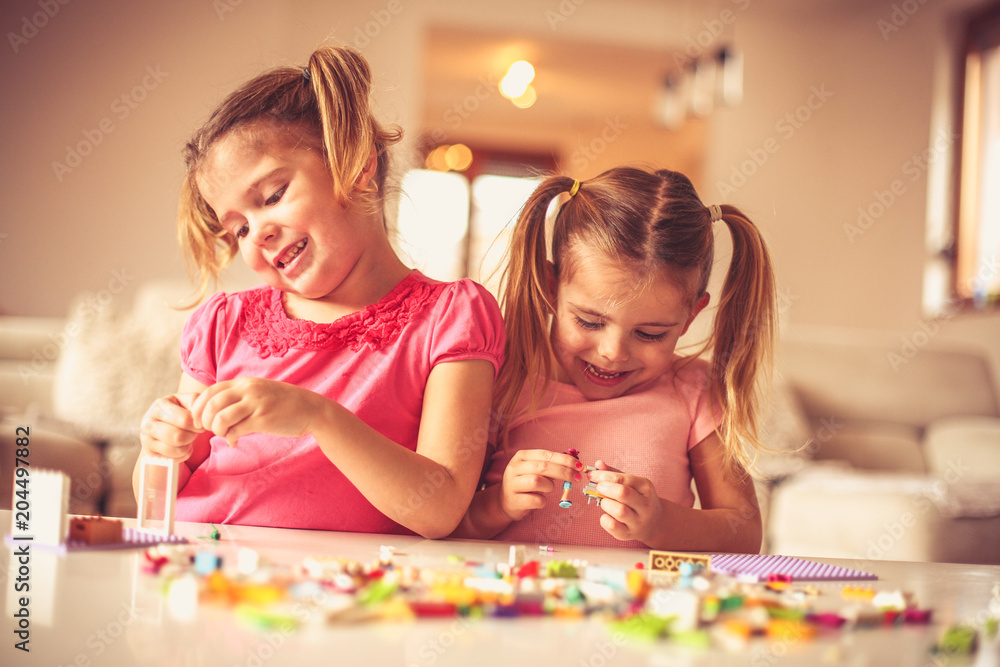 Fototapeta premium You build for self. Little girls playing.