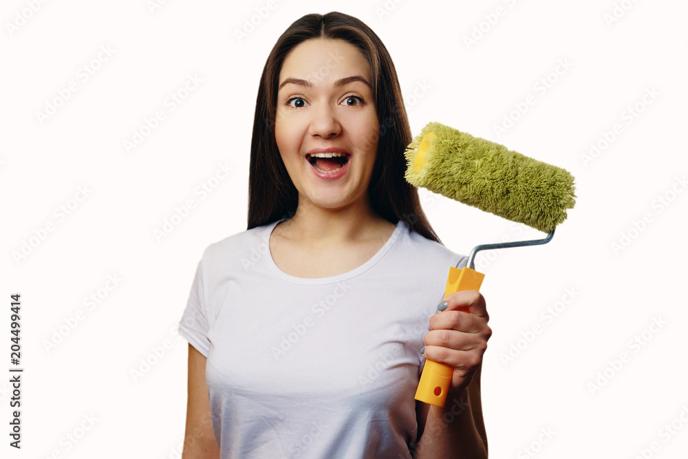 happy girl with paint roller close-up portrait on white isolated background, repair concept happy girl with paint roller close-up portrait on white isolated background, repair concept