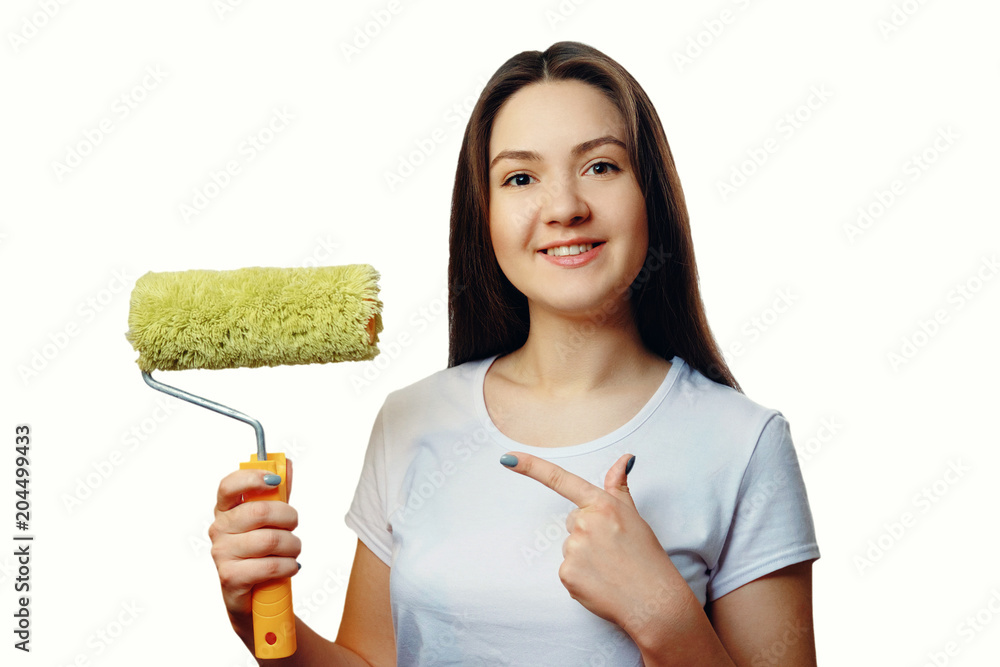 happy girl with paint roller close-up portrait on white isolated background, repair concept happy girl with paint roller close-up portrait on white isolated background, repair concept