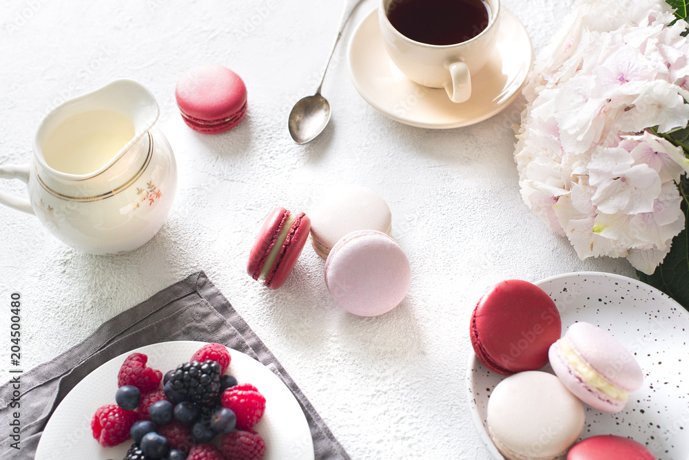 Fototapeta Spaing mood with color macaroons? cup of coffee and flowers