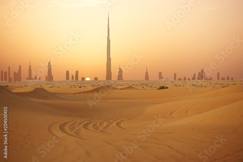 Dubai city skyline at sunset seen from the desert
