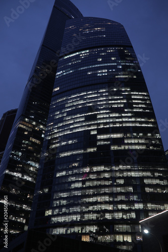 High of the modern business skyscrapers at night, the view from below.