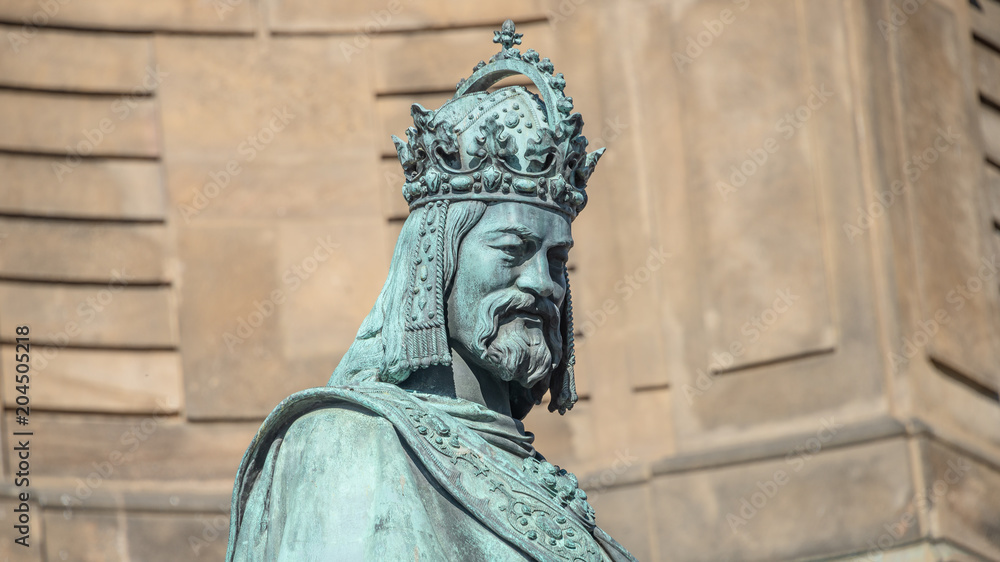 Statue of King Charles IV at Charles (Karluv most) Bridge Tower arched gateway in Prague, Czech Republic