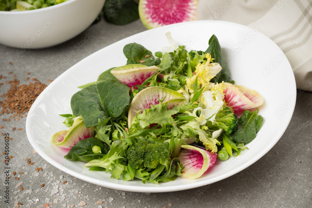 Fresh salad with watermelon radish,broccoli, green peas, spinach, green onions, lettuce leaves, flax seed. Healthy lifestyle. Vegan menu. Fresh salad with watermelon radish,broccoli, green peas, spinach, green onions, lettuce leaves, flax seed. Healthy lifestyle. Vegan menu.