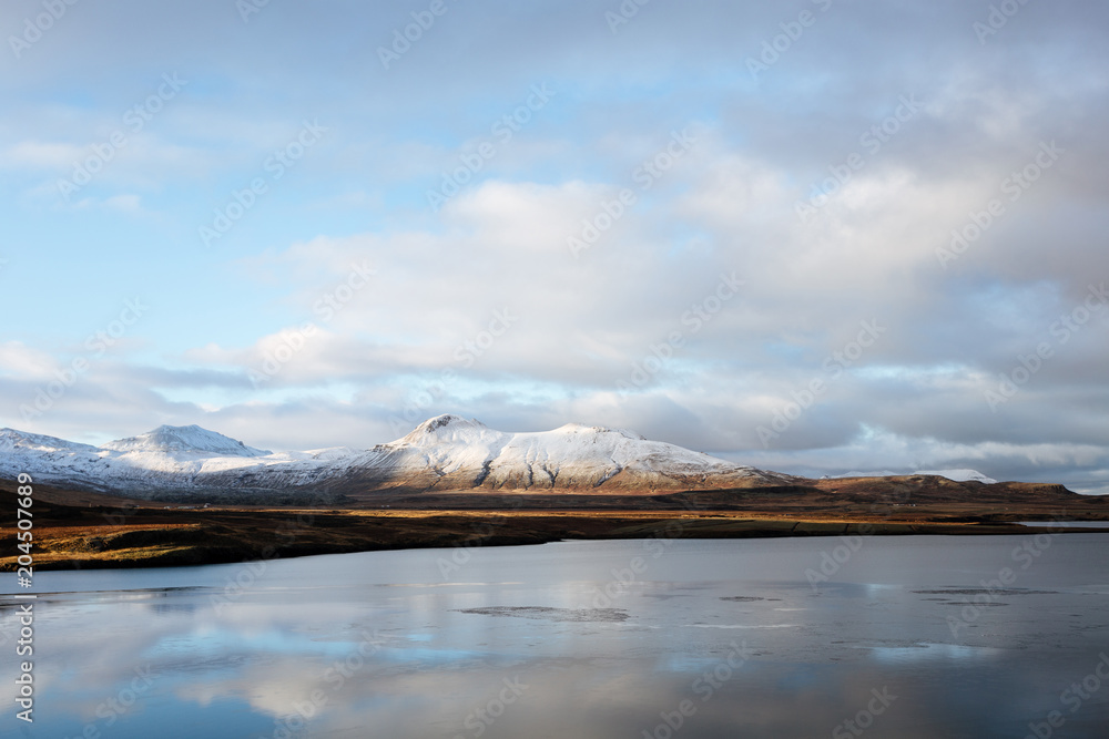 Fototapeta Mountain road leading to the peaks in Iceland.