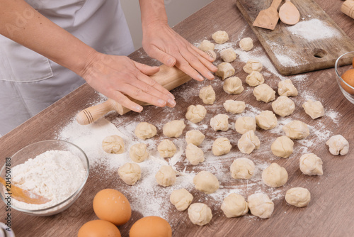 Preparing, cooking, making homemade ravioli, pelmeni or dumplings with meat