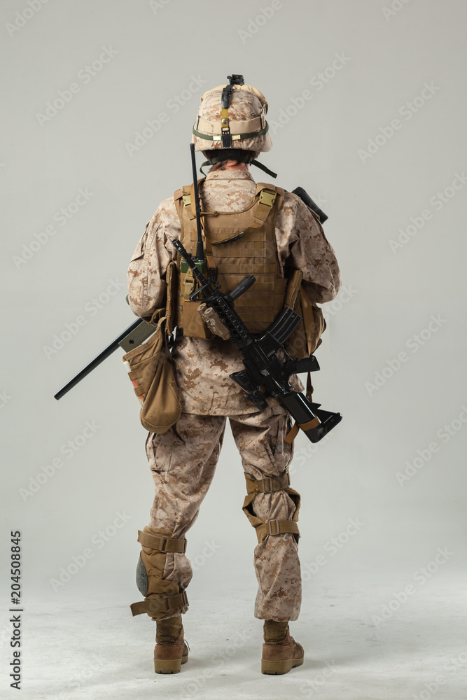Soldier in camouflage holding rifle Soldier in camouflage holding rifle