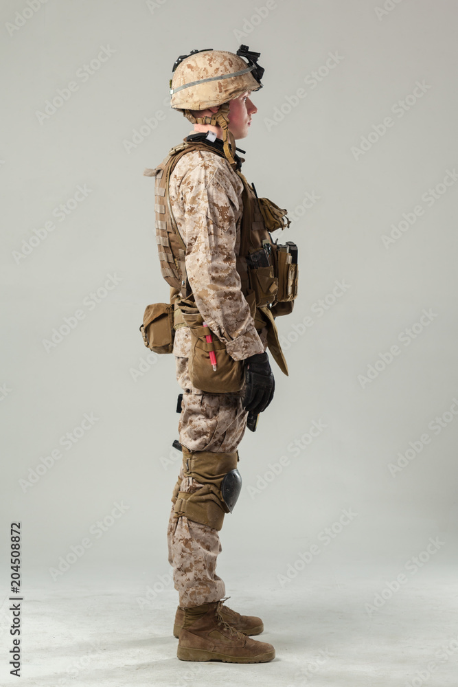 Soldier in camouflage holding rifle Soldier in camouflage holding rifle