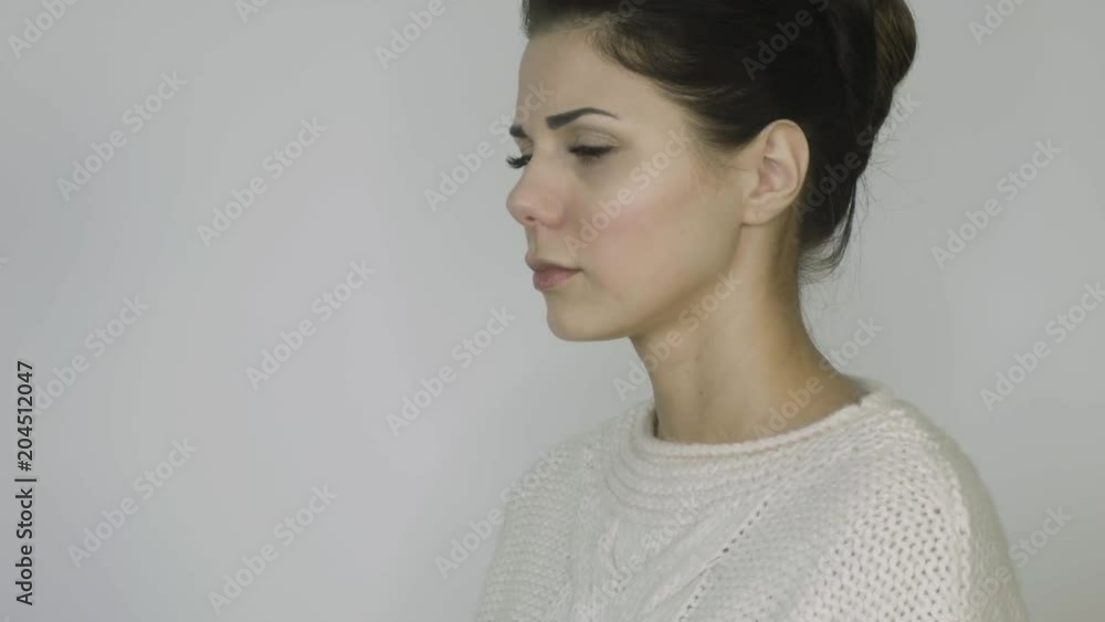 girl in a sweater sneezes on a white background girl in a sweater sneezes on a white background