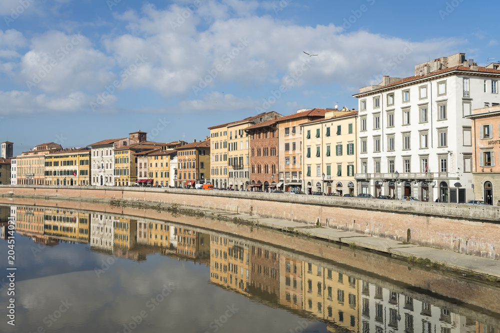 Facades of buildings on the banks of the Arno River on its way through Pisa.