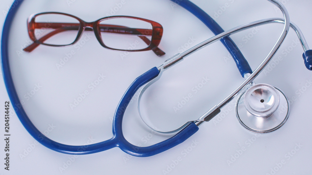 Doctor's workspace working table with patient's discharge blank paper form, medical prescription, stethoscope on desk, selective focus Doctor's workspace working table with patient's discharge blank paper form, medical prescription, stethoscope on desk, selective focus
