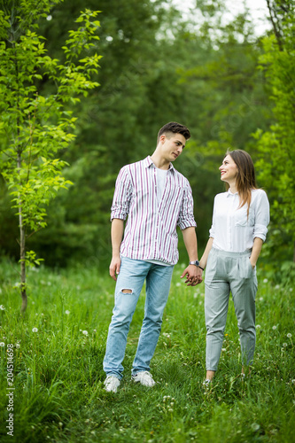 Beautiful young in love couple taking a walk in city park