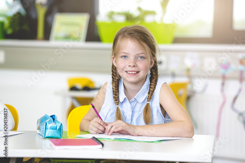 At school - Happy schoolchild in classroom