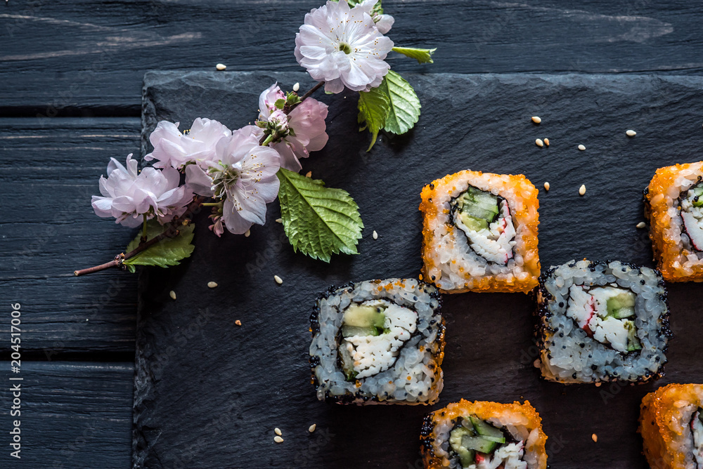 sushi and sakura on the table sushi and sakura on the table