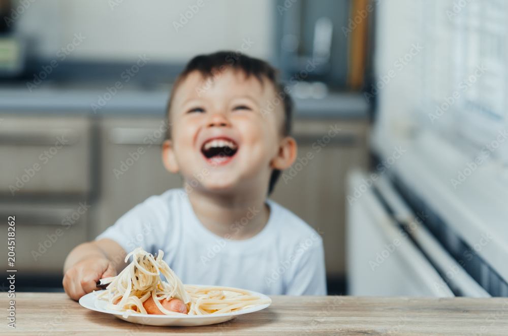 the child eats pasta with a fork and shouts rejoices very much the child eats pasta with a fork and shouts rejoices very much