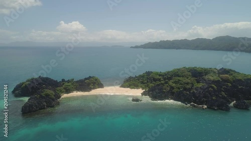 Aerial view islands with sand beach Lahus and turquoise water in blue lagoon among coral reefs, Caramoan Islands, Philippines. Landscape with sea, tropical beach. photo