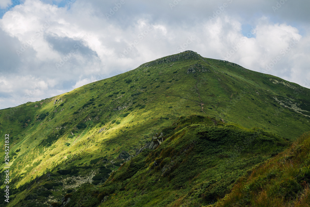 Beautiful view of the green hills and clouds in the Carpathian Mountains Beautiful view of the green hills and clouds in the Carpathian Mountains