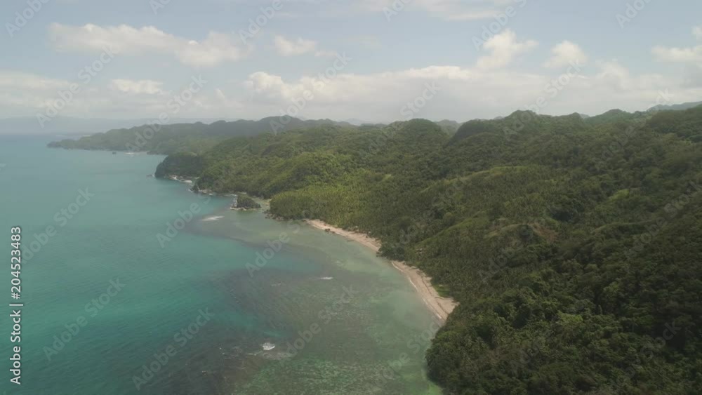 Aerial view coastline with beach and mountains covered with tropical forest in province Caramoan, Philippines. Landscape with sea, mountains and beach. Aerial view coastline with beach and mountains covered with tropical forest in province Caramoan, Philippines. Landscape with sea, mountains and beach.