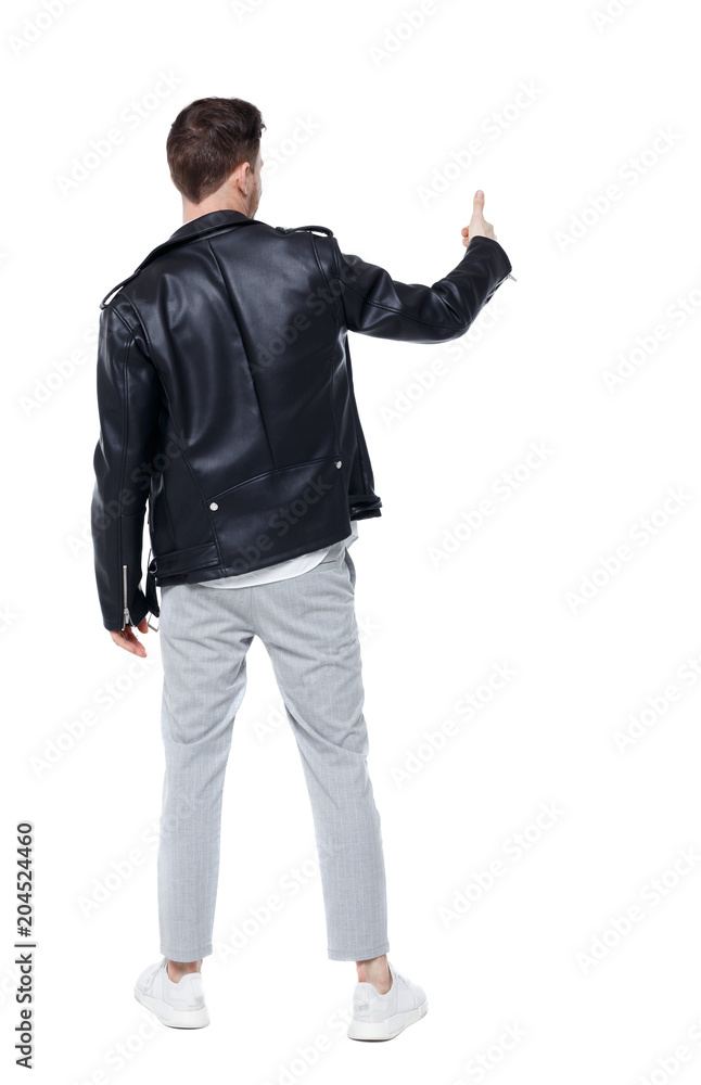 Back view of a man in a leather jacket showing thumb up Back view of a man in a leather jacket showing thumb up