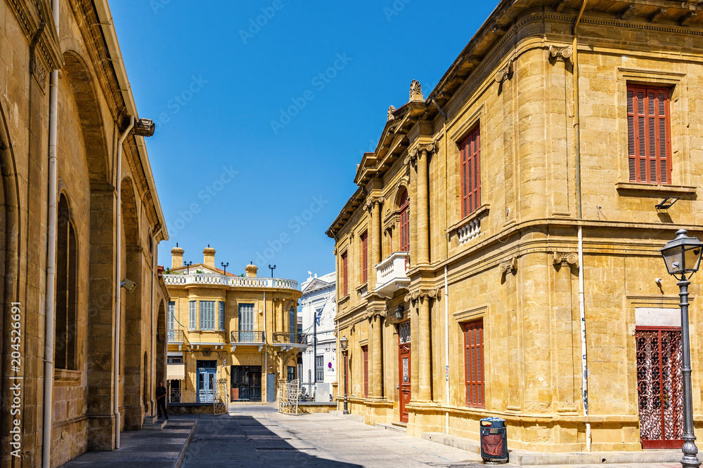 Daylight view to old city streets with stone ornamented buildings