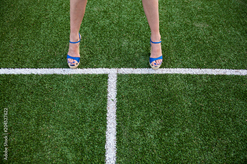 Woman legs on the soccer field