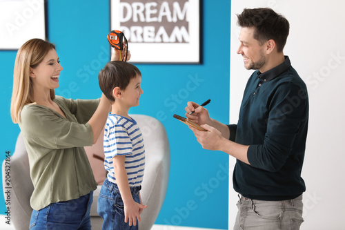 Parents measuring height of...