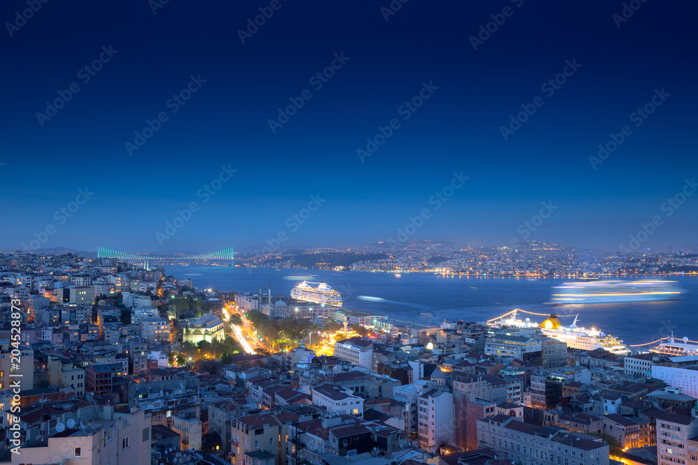 Long exposure cityscape of Istanbul at a night from Galata to the Bosphorus. Wonderful romantic old town at Sea of Marmara. Bright light of street lighting and cruise liners. Istanbul. Turkey.