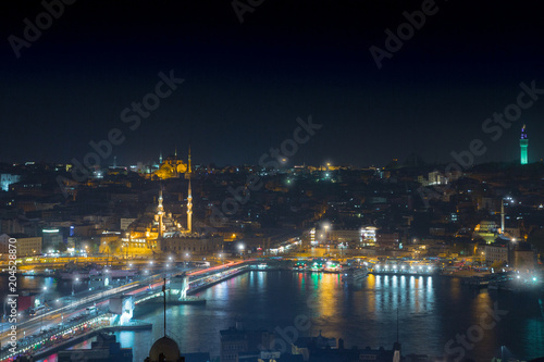 Long exposure cityscape of Istanbul at a night. Galata bridge on Golden Horn gulf. Wonderful romantic old town at Sea of Marmara. Bright light of street lighting and various ships. Istanbul. Turkey. © Sodel Vladyslav