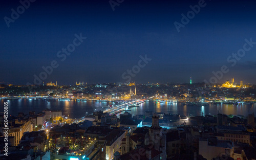 Long exposure cityscape of Istanbul at a night. Galata bridge on Golden Horn gulf. Wonderful romantic old town at Sea of Marmara. Bright light of street lighting and various ships. Istanbul. Turkey. © Sodel Vladyslav