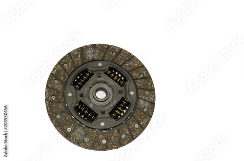 a clutch disk on a black background, a brake disc, a spare part for a car,