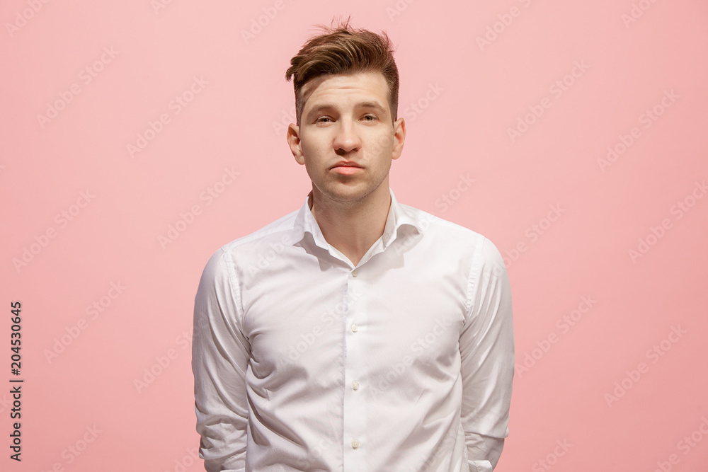 Let me think. Doubtful pensive man with thoughtful expression making choice against pink background Let me think. Doubtful pensive man with thoughtful expression making choice against pink background
