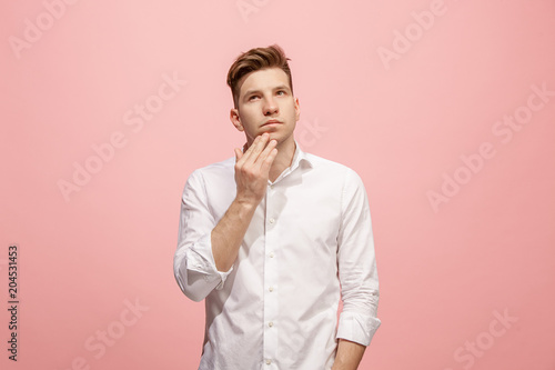 Young serious thoughtful businessman. Doubt concept.