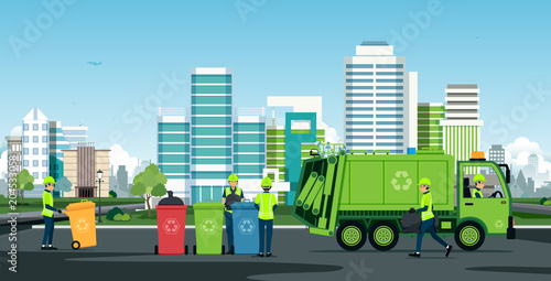 Workers are working with garbage trucks with backdrop buildings.