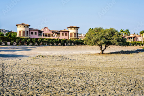 Daylight view to buildings near beach with car tires traces
